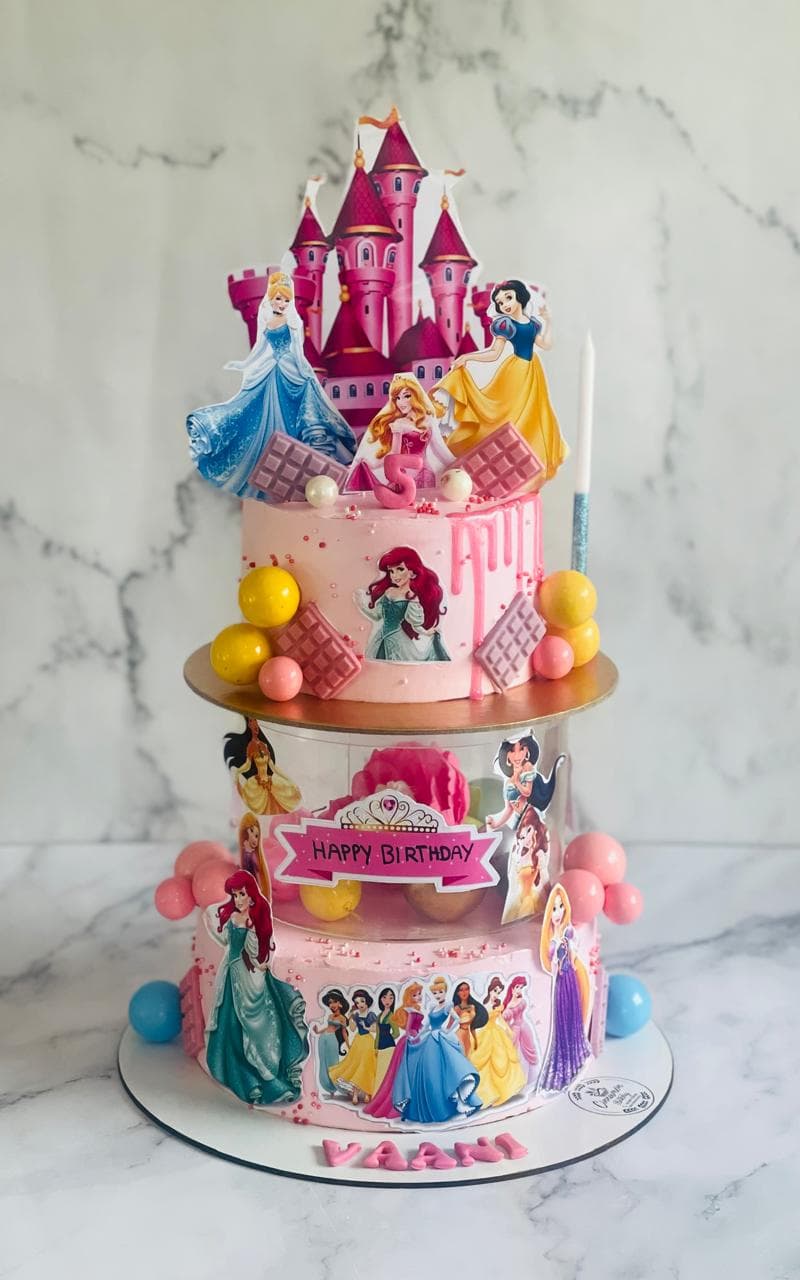 Three-tier princess castle birthday cake with character figurines